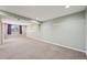 Spacious finished basement area featuring neutral carpeting and a window for natural light at 17476 E Bellewood Cir, Aurora, CO 80015