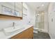 Bright bathroom features modern vanity, updated fixtures, and a glass enclosed shower at 17476 E Bellewood Cir, Aurora, CO 80015