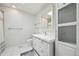 Bright bathroom with storage cabinet, tile floors, and modern mirror at 17476 E Bellewood Cir, Aurora, CO 80015