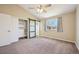 Bright bedroom features a ceiling fan, double closets, and a sliding barn door at 17476 E Bellewood Cir, Aurora, CO 80015