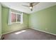 Bedroom features neutral carpet, green walls, and window with white curtains at 17476 E Bellewood Cir, Aurora, CO 80015
