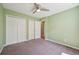 Spacious bedroom with plush carpet, light green walls, and a double closet at 17476 E Bellewood Cir, Aurora, CO 80015