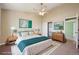 Bright bedroom with a ceiling fan, closet, and view into the living area at 17476 E Bellewood Cir, Aurora, CO 80015