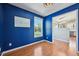 Bright blue dining room featuring a window, hardwood floors, and wall-mounted whiteboard at 17476 E Bellewood Cir, Aurora, CO 80015