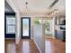 Open entryway with gleaming hardwood floors, neutral paint, and view of dining area at 17476 E Bellewood Cir, Aurora, CO 80015