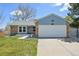 Charming single-Gathering home featuring a brick and blue facade, a well-manicured lawn, and a two-car garage at 17476 E Bellewood Cir, Aurora, CO 80015