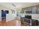 Kitchen features stainless steel appliances, gray cabinets, pendant lighting, and breakfast nook at 17476 E Bellewood Cir, Aurora, CO 80015
