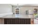 The kitchen island features bar seating and stainless steel appliances at 17476 E Bellewood Cir, Aurora, CO 80015