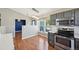 Kitchen features stainless steel appliances, gray cabinets, pendant lighting, and breakfast nook at 17476 E Bellewood Cir, Aurora, CO 80015