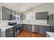 Kitchen features stainless steel appliances, gray cabinets, and white countertops at 17476 E Bellewood Cir, Aurora, CO 80015