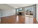 Bright living room with wood floors, fireplace, and sliding glass doors that let in natural light at 17476 E Bellewood Cir, Aurora, CO 80015