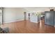 Open living room with wood floors next to kitchen at 17476 E Bellewood Cir, Aurora, CO 80015