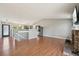 Open living space featuring hardwood floors, a fireplace, and a view of the kitchen at 17476 E Bellewood Cir, Aurora, CO 80015
