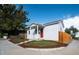 Charming home with fresh landscaping, including a grassy lawn and decorative mulch, under a partly cloudy sky at 3903 W Nevada Pl, Denver, CO 80219