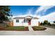 Charming single-story home with a red door, manicured front lawn, and inviting curb appeal at 3903 W Nevada Pl, Denver, CO 80219