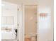 Hallway view to a bedroom and bathroom with white subway tile shower at 3903 W Nevada Pl, Denver, CO 80219