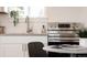 Close-up of a modern kitchen with stainless steel oven, sink, and bright natural light at 3903 W Nevada Pl, Denver, CO 80219