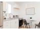 Bright kitchen features stainless steel appliances, white cabinets and gray countertops at 3903 W Nevada Pl, Denver, CO 80219