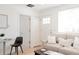 Cozy living room with comfortable beige sofa, white pillows and bright natural light at 3903 W Nevada Pl, Denver, CO 80219