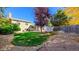 Landscaped backyard with grassy area, gravel pathway, and storage shed at 2519 S Sable Way, Aurora, CO 80014