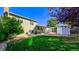 View of the backyard with patio, shed, and lawn at 2519 S Sable Way, Aurora, CO 80014