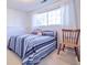 Bright bedroom with striped bedding and a wooden chair at 2519 S Sable Way, Aurora, CO 80014