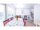 Dining area with built-in shelving, red chairs, and view to backyard at 2519 S Sable Way, Aurora, CO 80014