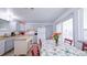 Kitchen and dining area with floral tablecloth, red chairs, and sliding glass doors to backyard at 2519 S Sable Way, Aurora, CO 80014