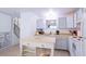 Bright kitchen with light gray cabinets, wood countertops, and modern appliances at 2519 S Sable Way, Aurora, CO 80014