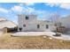 Exterior shot showcasing the backyard with a concrete patio and small stone fire pit at 2010 E 125Th Pl, Thornton, CO 80241