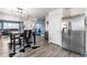 Open concept kitchen with stainless steel appliances, stylish dining table, and seamless living space at 2010 E 125Th Pl, Thornton, CO 80241