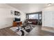 Cozy living room with a comfortable brown couch, a large window, and stylish decor at 2010 E 125Th Pl, Thornton, CO 80241