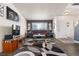 Comfortable living room with stylish decor, natural light, and a large flat-screen television at 2010 E 125Th Pl, Thornton, CO 80241