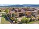 Aerial view of a backyard featuring a patio with an outdoor grill, fire pit, and mountain views at 15179 W Washburn Ave, Lakewood, CO 80228