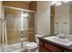 Well-lit bathroom with glass-enclosed shower, stylish fixtures, and a modern vanity with ample counter space at 15179 W Washburn Ave, Lakewood, CO 80228