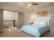Comfortable bedroom with ceiling fan and artwork near stairs and grey doors at 15179 W Washburn Ave, Lakewood, CO 80228