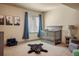 Charming Bedroom with stylish crib, mountain artwork, and whimsical bear rug, creating a comforting space at 15179 W Washburn Ave, Lakewood, CO 80228
