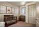 Bright Bedroom with a crib, dresser, and a soothing color scheme for a cozy environment at 15179 W Washburn Ave, Lakewood, CO 80228