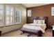 Comfortable bedroom featuring a decorative blanket, bench, and abundant natural light at 15179 W Washburn Ave, Lakewood, CO 80228
