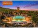 Aerial view of the Solterra community pool featuring a tower, lush landscaping, and lounge areas at 15179 W Washburn Ave, Lakewood, CO 80228