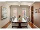 Formal dining room with modern decor, coffered ceilings, and ample seating for large gatherings at 15179 W Washburn Ave, Lakewood, CO 80228