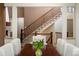 Dining area showcasing stairs with iron railings and a decorative table centerpiece with fresh flowers at 15179 W Washburn Ave, Lakewood, CO 80228