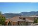 Beautiful mountain view over the roofs of homes with terra cotta colored tile at 15179 W Washburn Ave, Lakewood, CO 80228