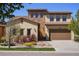 Beautiful two-story home with stone accents, a two-car garage, and a well-manicured lawn at 15179 W Washburn Ave, Lakewood, CO 80228