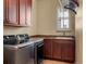 Laundry room with a sink, modern washer and dryer and storage cabinets at 15179 W Washburn Ave, Lakewood, CO 80228