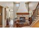 Spacious living room featuring a stone fireplace, high ceilings, and an open floor plan at 15179 W Washburn Ave, Lakewood, CO 80228