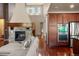 Open living room features a stone fireplace, hardwood floors and modern design at 15179 W Washburn Ave, Lakewood, CO 80228