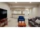 Cozy basement living room features a wet bar, comfortable seating, and plenty of space for entertaining guests at 15179 W Washburn Ave, Lakewood, CO 80228