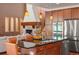A great room with stone fireplace, hardwood floors and kitchen island view at 15179 W Washburn Ave, Lakewood, CO 80228