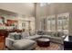 Open-concept living area with ample windows, modern furnishings, and hardwood flooring at 15179 W Washburn Ave, Lakewood, CO 80228